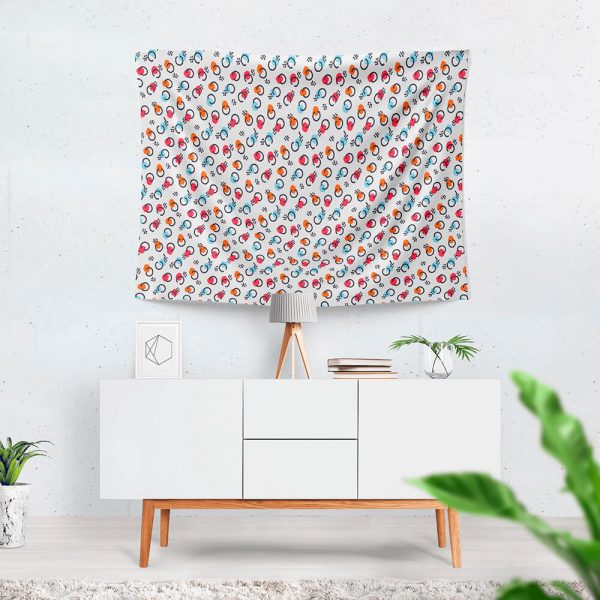 A patterned cute tapestry hangs on the wall, with a table beneath it.