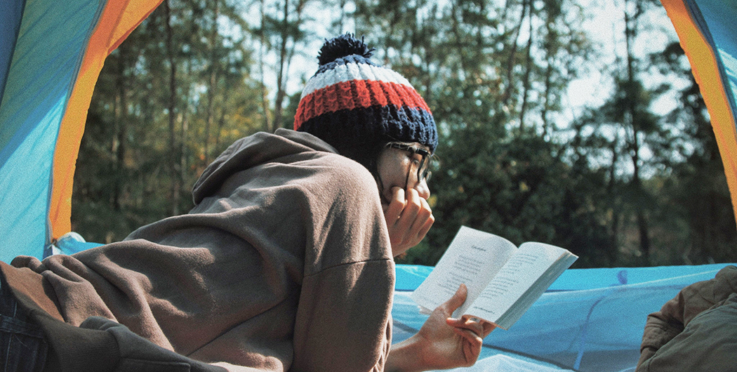 JetPrint Guides A girl is reading a book in a tent