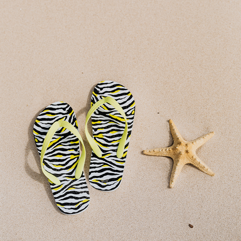 beach flip flops A pair of flip flops placed on the beach