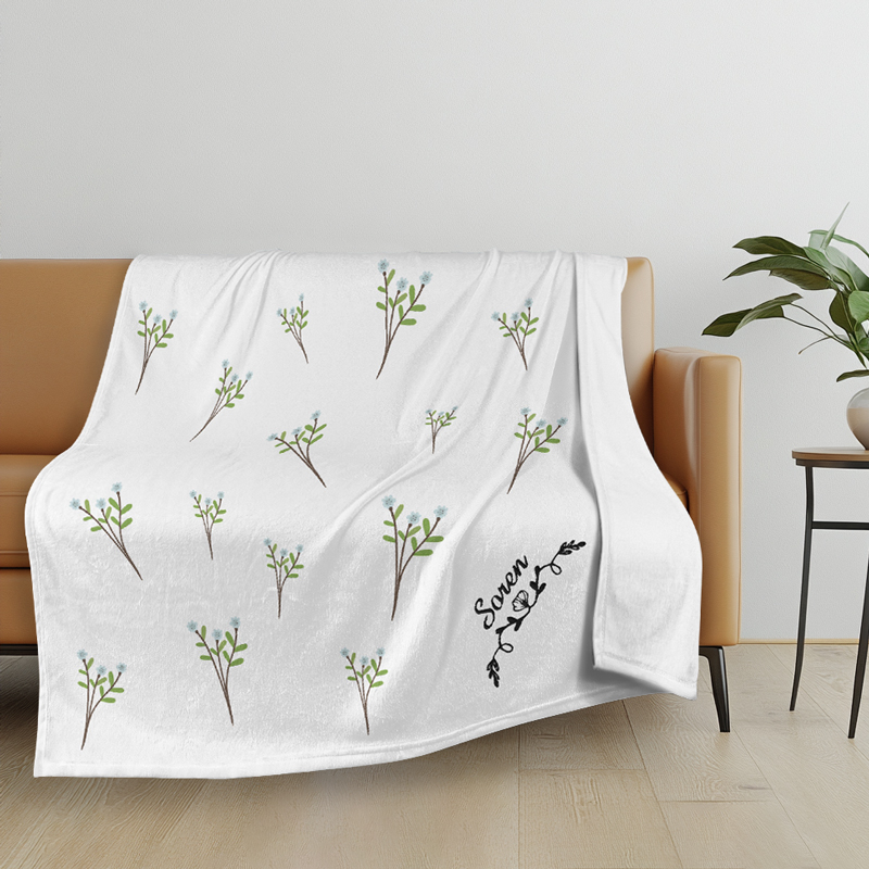 Blanket with embroidered letters An embroidered blanket sits on the sofa
