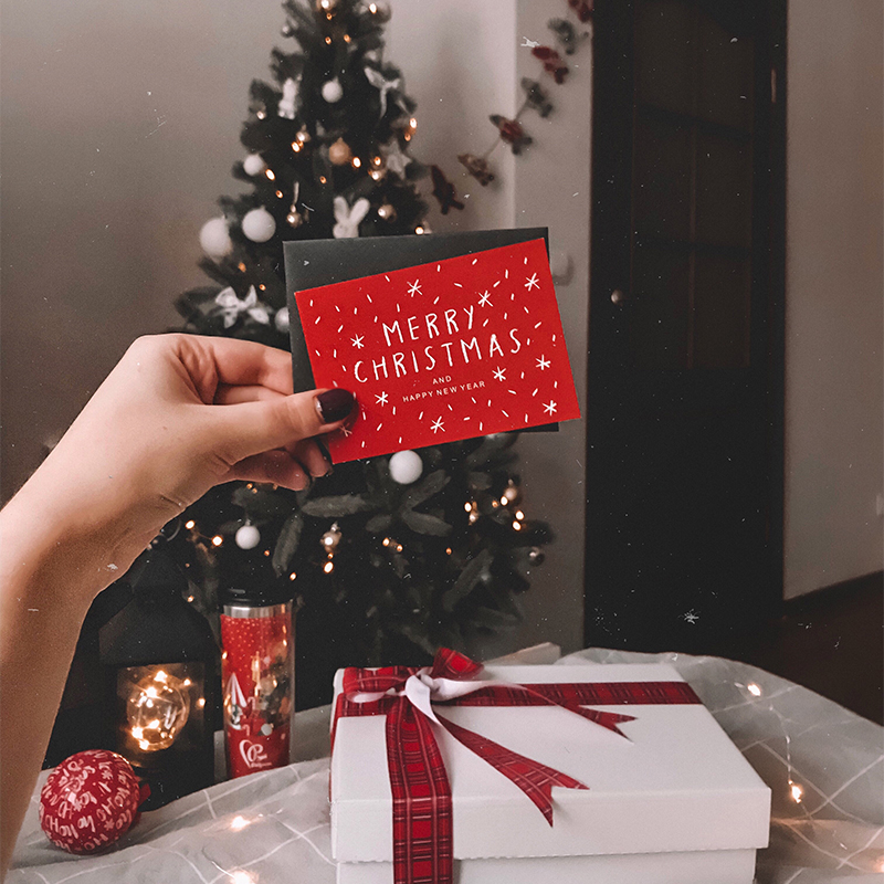 Christmas greeting card A person holds a Christmas card