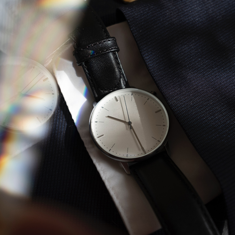 Create your own watch brand A black watch is placed on the table