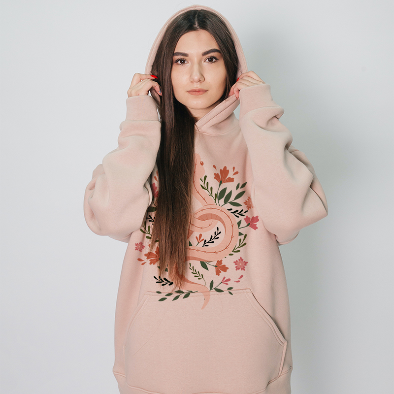 Customize Your Own Hoodie A female model wears a pink hoodie of her own design