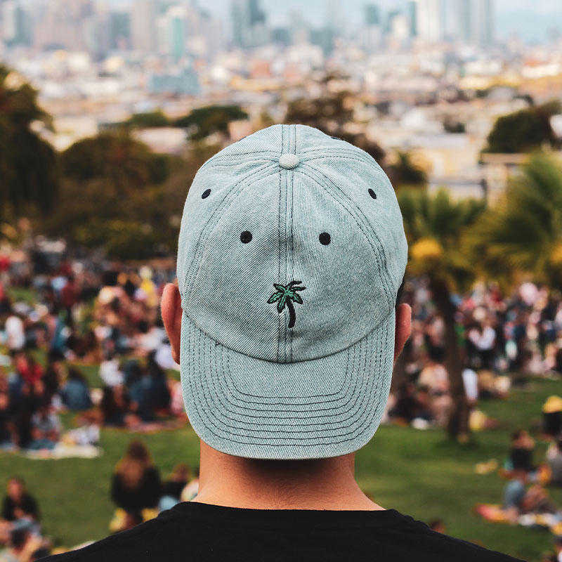 Design and sell pod hats with JetPrint A man wears a light blue embroidered baseball cap