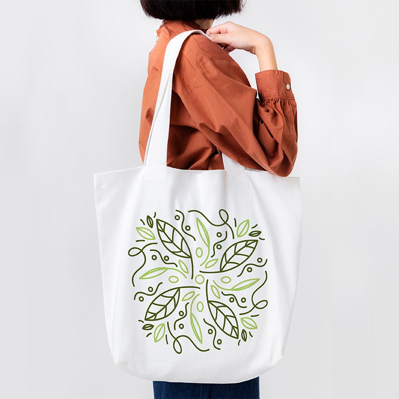 fashion bag A female model is carrying a bag with a green design pattern