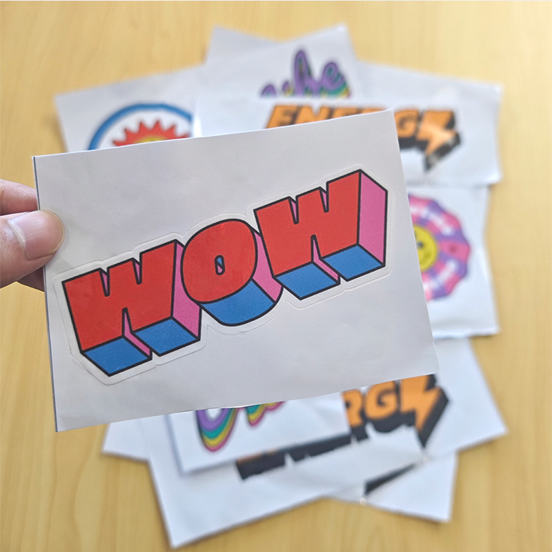 Kiss Cut Stickers (1) A kiss-cut sticker with the word "WOW"