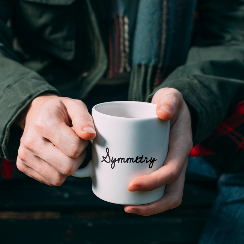 Mug with name A person holding a white mug with a name on it