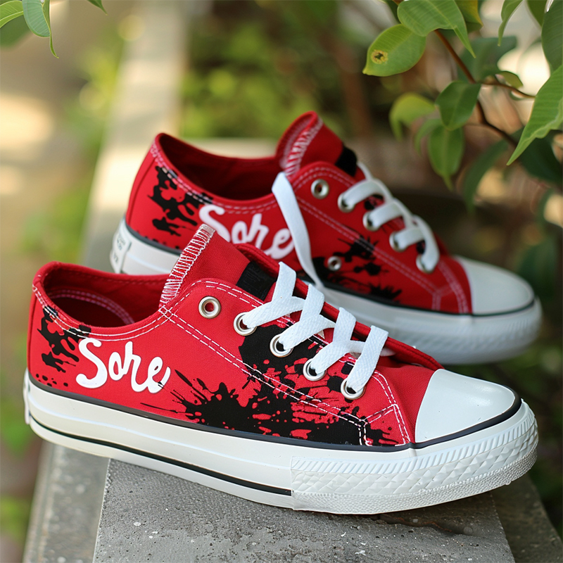 Personalized text style shoes-1 A pair of red low-top canvas shoes with personalized text