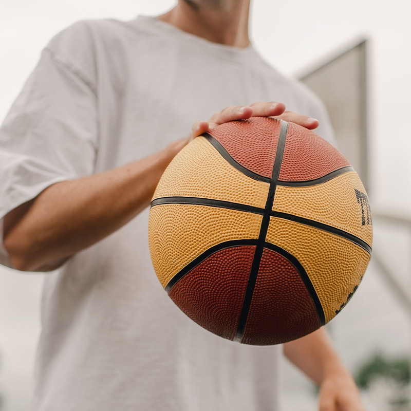 Play basketball A man in white clothes is playing basketball