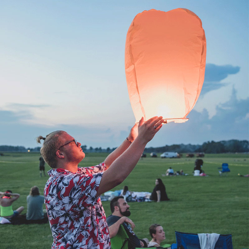 What fabric are Hawaiian shirts made from A man wearing a Hawaiian shirt is playing Sky lantern