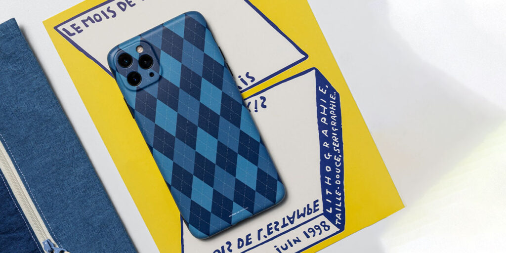 A blue mobile phone case is placed on the desk